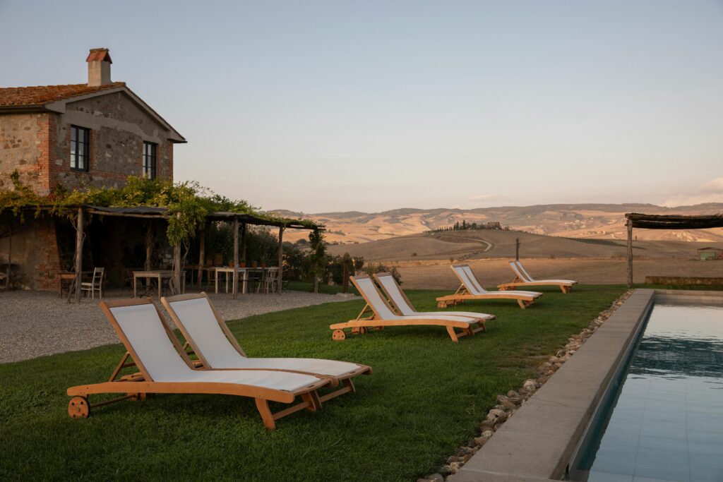 outside of farmhouse with pool and loungers