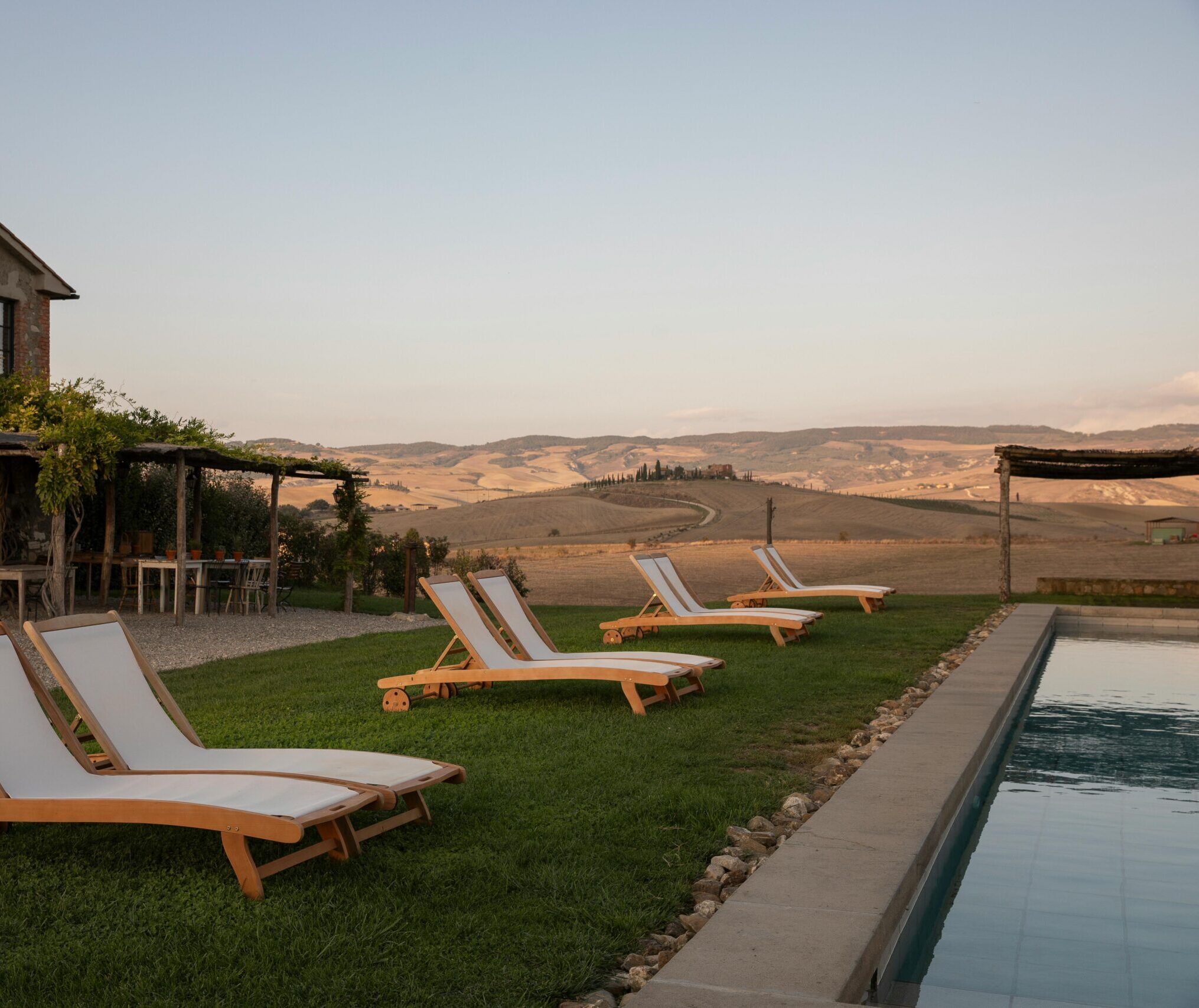 outside of farmhouse with pool and loungers