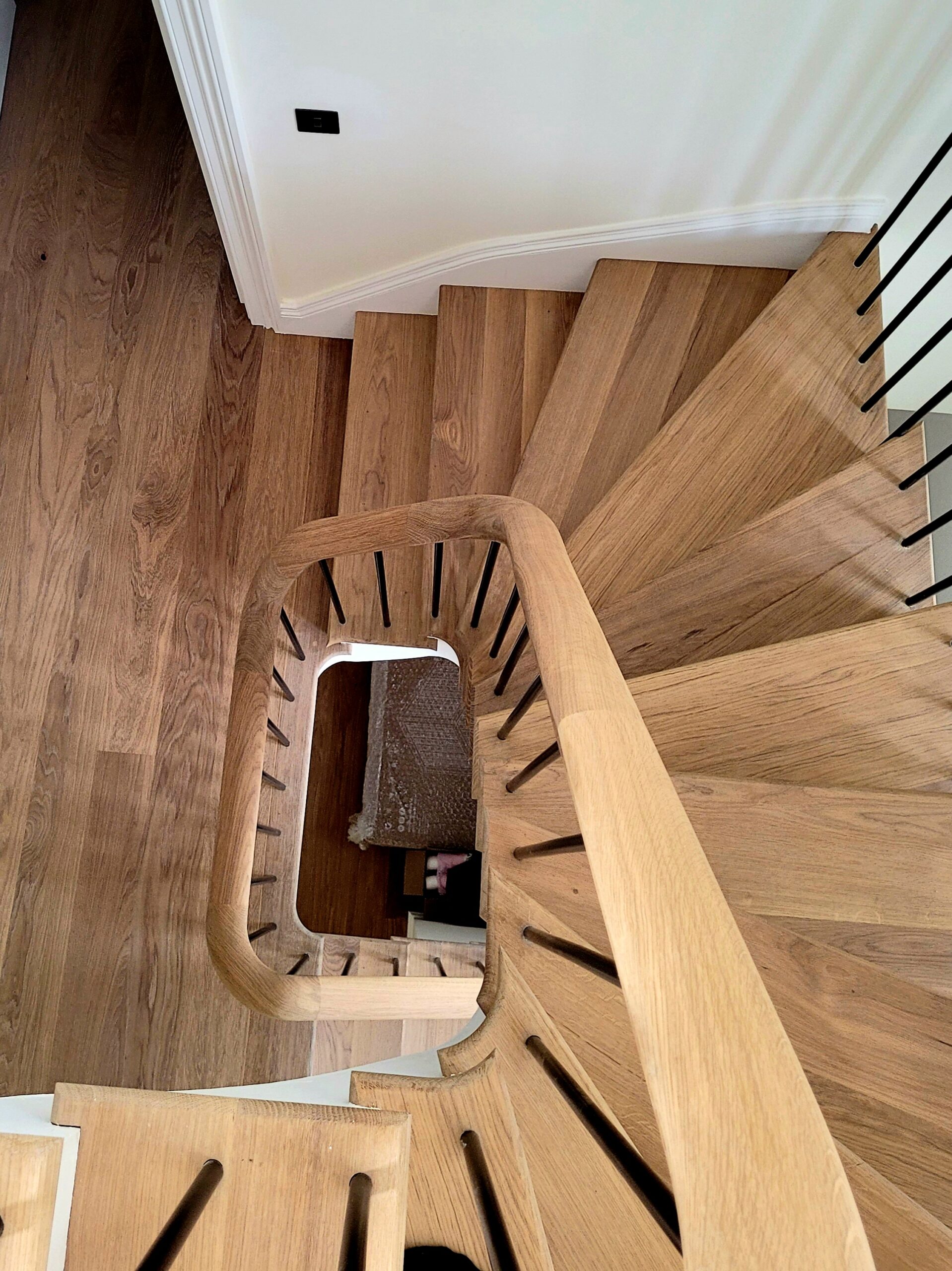 view from the top of a curved staircase